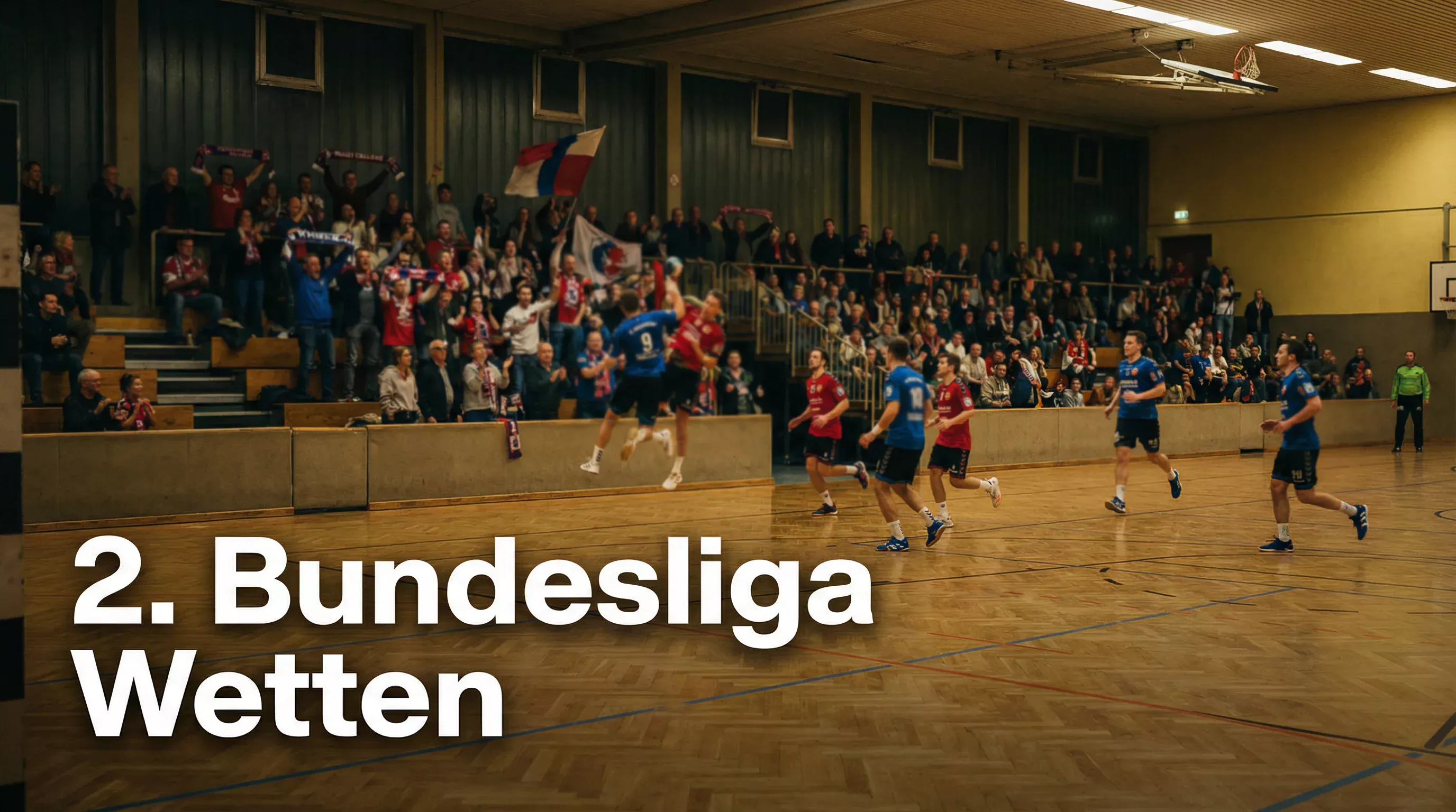 Handball-Spiel in einer kleineren Halle der 2. Bundesliga mit engagierten Fans auf der Tribüne